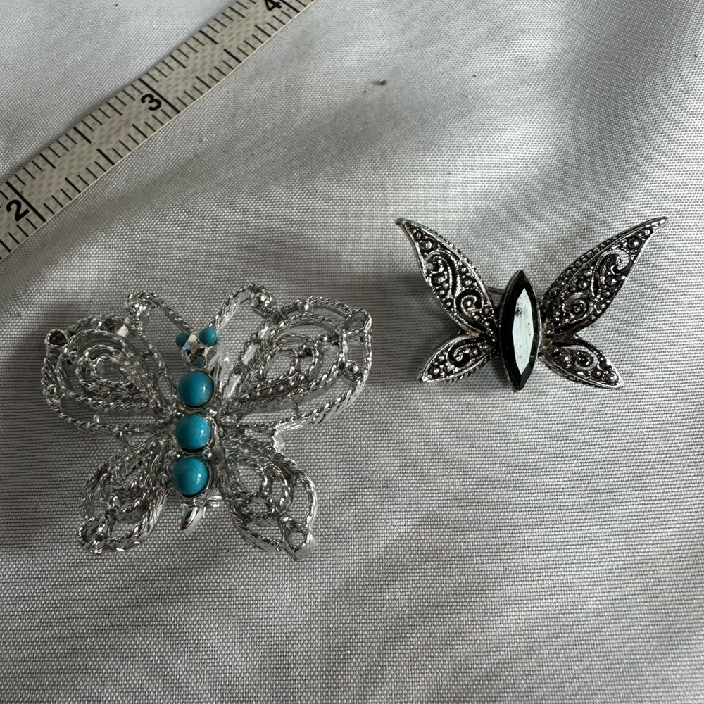 Two smaller style silvertone butterfly pins